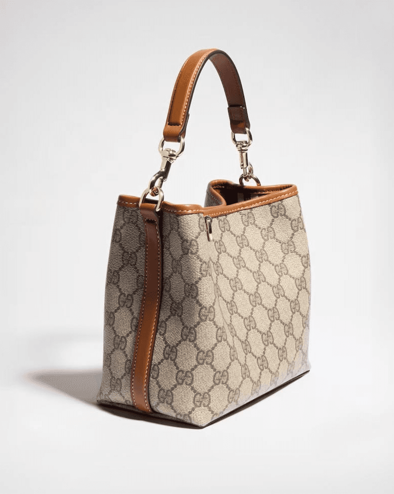 Monogram canvas handbag with a tan leather top handle
